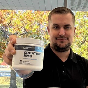 Chris Bader holding a Creatine HMB container