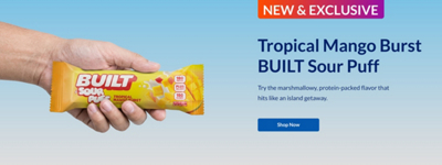 Man holding One Built Sour Puff Tropical Mango Burst bar