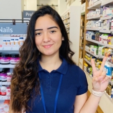 dark haired woman showing peace sign