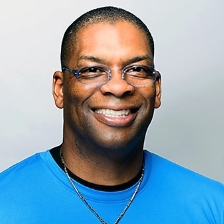 man with glasses smiling