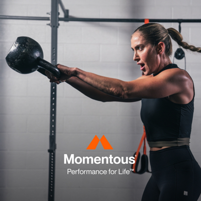 Momentous Performance for Life. Women lifting heavy kettle ball.