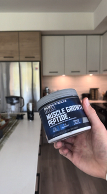 Man holding BodyTech Elite Muscle Growth product