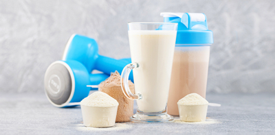 Protein Powder Powder-Ups.  Crush your goals from muscle building and recovery to energy, weight control, and more is written in dark blue font.  Image is also showing 3 scoops with protein powder, dumbbells, protein shakes and protein bars