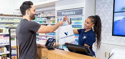 employee handing purchased products to customer